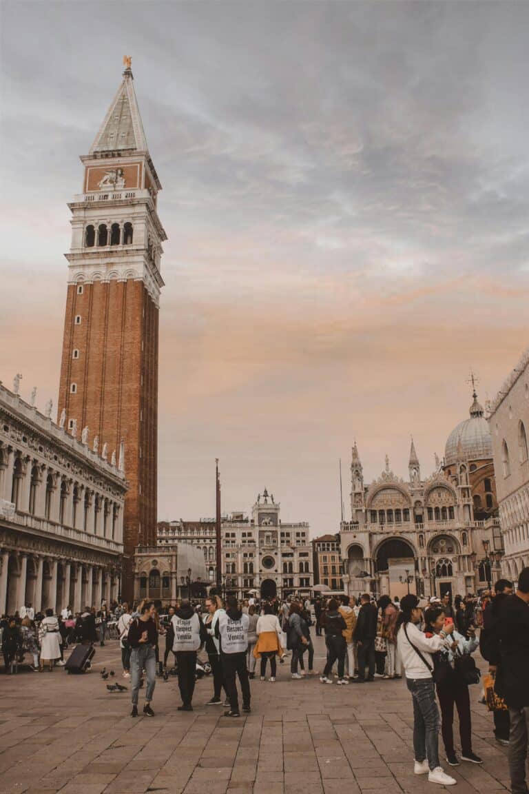 Tourists gathering at St. Mark’s Square in Venice, Italy, with stewards wearing “Respect Venice” vests